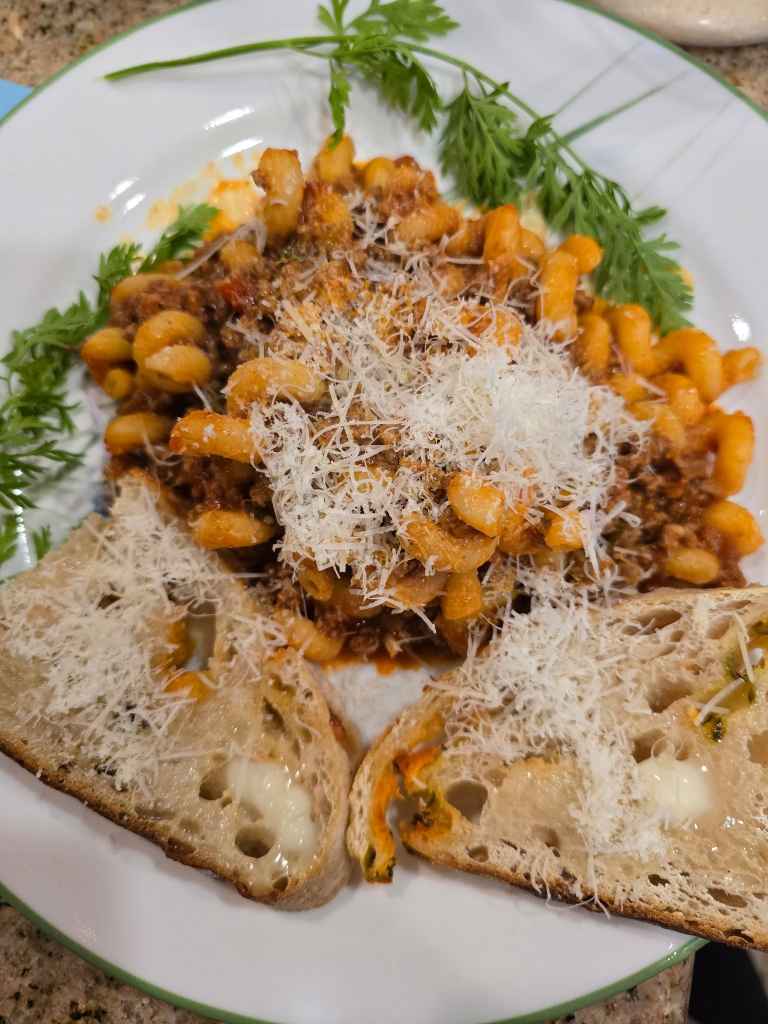Sourdough bread with pasta in rich meat sauce